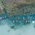 Overhead shot of a little dock at the coast with parked fishing boats