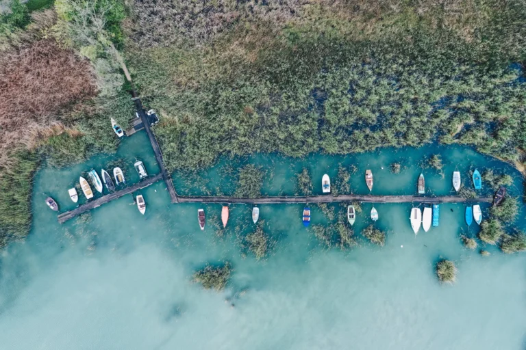 Overhead shot of a little dock at the coast with parked fishing boats
