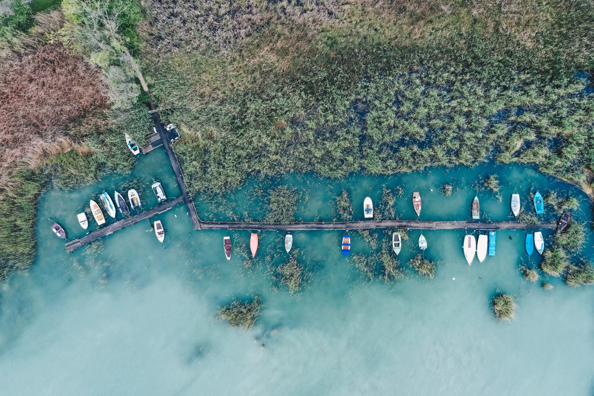 Overhead shot of a little dock at the coast with parked fishing boats